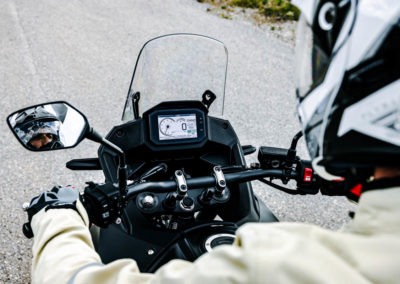 Rider enjoying scenic overlook with Honda Transalp parked nearby