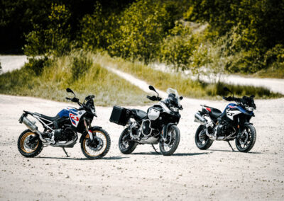 2024 BMW F 900 GS Adventure parked in a rugged terrain, highlighting its off-road capabilities.