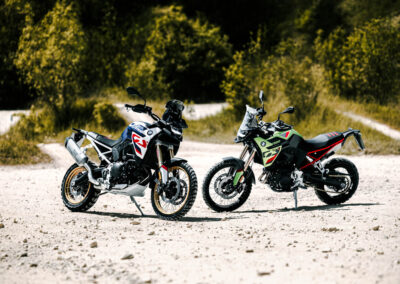 2024 BMW F 900 GS Adventure parked in a rugged terrain, highlighting its off-road capabilities.