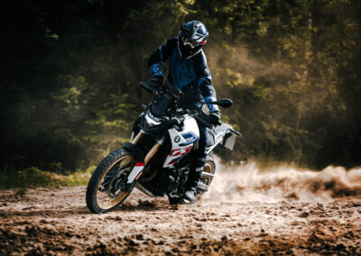 Dynamic action shot of the BMW F 900 GS navigating challenging off-road conditions, demonstrating its agility and power