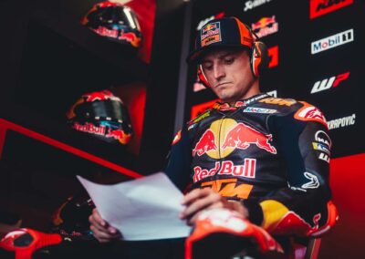 The Red Bull KTM team analyzing data during a night session at the 2024 Qatar Test