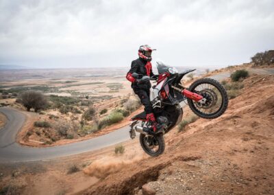 Ducati DesertX Rally 2024 in action on off-road terrain.