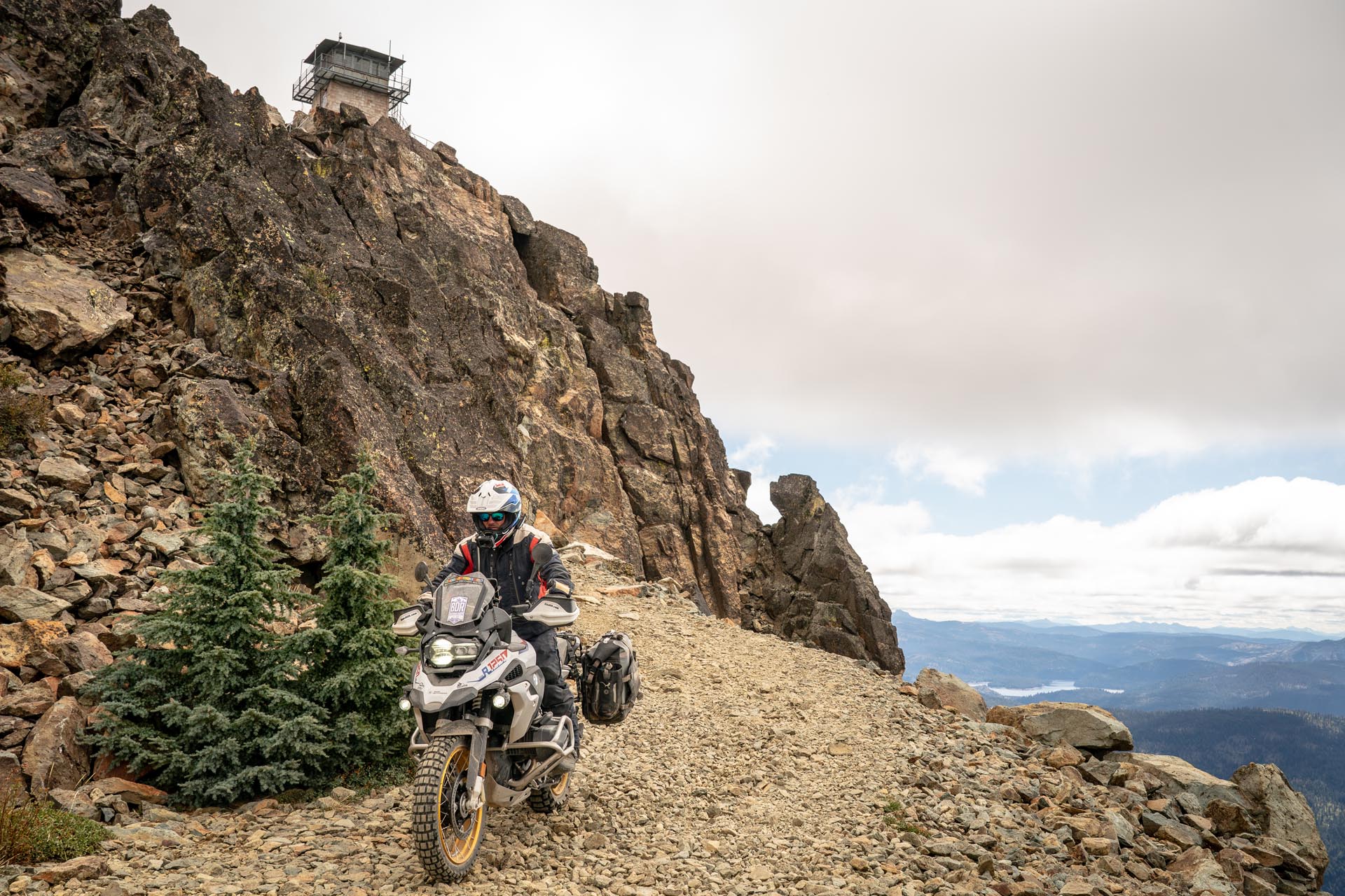 BMW R1250GS parked at a high-altitude fire lookout on an epic motorcycle travel route.