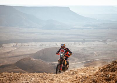 A Honda rider navigates rocky landscapes in the intense second week of the adventure rally.