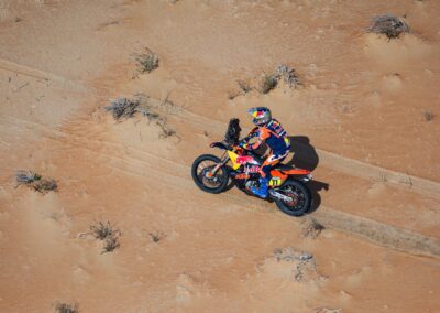 A Honda rider navigates rocky landscapes in the intense second week of the adventure rally.